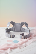 Premium posture corrector on luxury white marble surface, pastel background, soft lighting